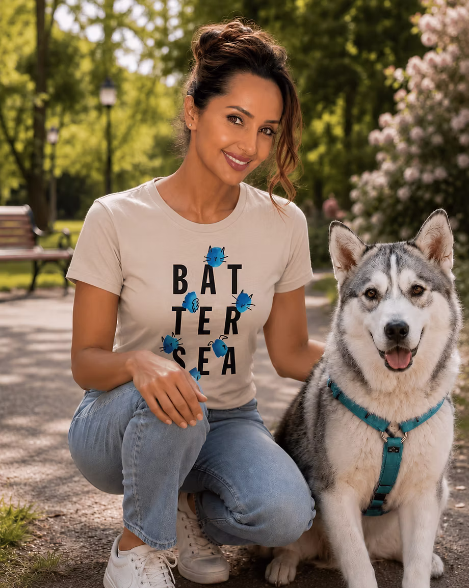 A FurFix supporter in a Battersea T-shirt, crouched beside a husky in a park